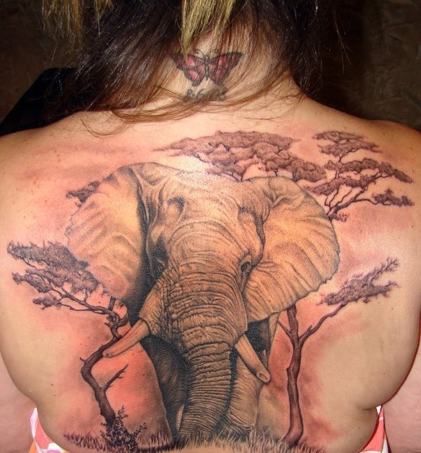 Precioso tatuaje de un elefante con un fondo de rboles simulando la sabana