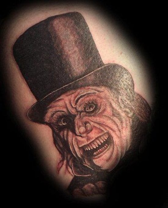 Tatuaje de un mago con rasgos de vampiro, al que se le ha tatuado un gran sombrero de copa y unas imponentes arrugas en la cara para definir que es un mago de alta edad