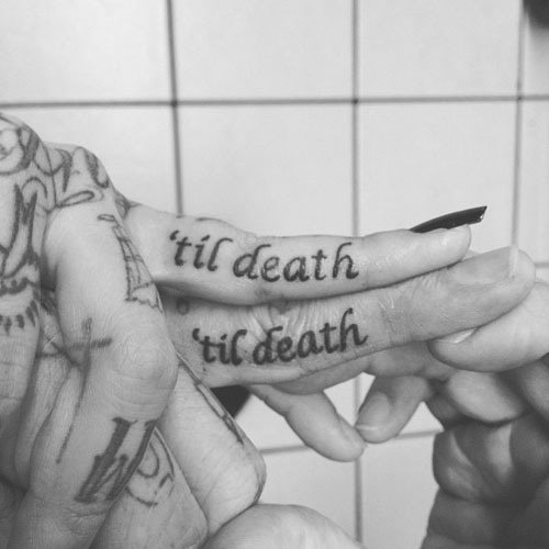Tatuaje de pareja realizado en los dedos, tanto él como ella, llevan tatuada la misma frase que dice til death, como podemos ver es una pareja que ama los tatuajes y que también se aman entre ellos, de ahí que hayan querido dejar muestra de su amor a través de un tattoo