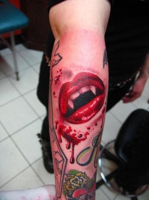 Tatuaje de unos labios rojos a los que se les ha tatuado unos dientes blancos con grandes colmillos, típicos de los vampiros y el fondo negro