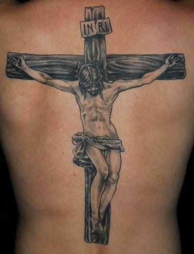 Tatuaje de Cristo crucificado sobre una gran cruz de madera con la clásica inscripción de INRI, que significa Ievs Nazarenvs Rex Ivdaeorvm, en castellano 