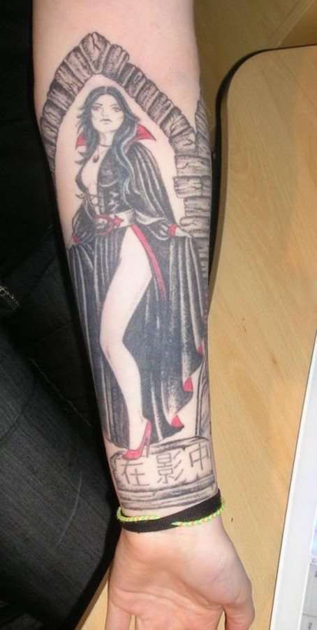 Tatuaje de una mujer vampiro con una capa típica de vampiro con cuellos en color rojo levantados