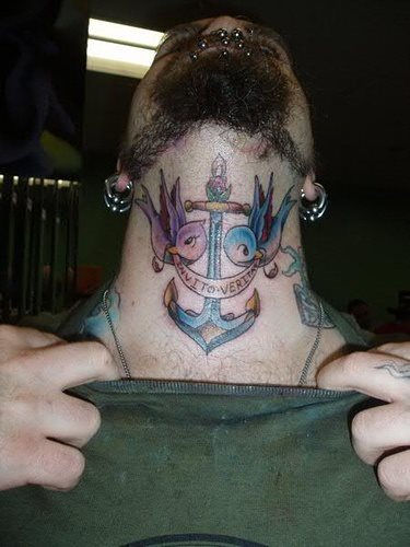 Tatuarse el cuello es una decisión difícil, en esta ocasión este hombre ha optado por tatuar un ancla custodiado por dos pájaros de colores que llevan sobre su pico un lazo con alguna inscripción