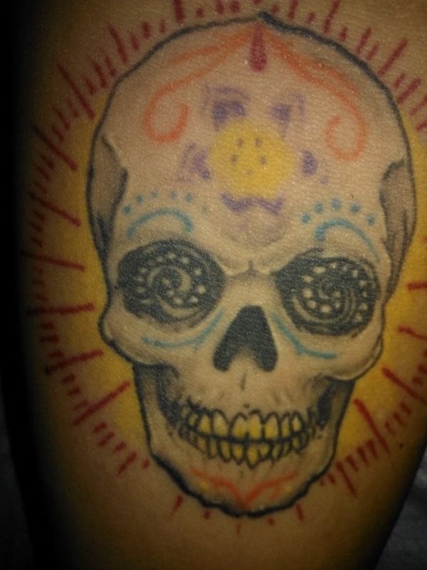 Tatuaje de una colorida calavera mexicana, en la que tal vez repasando los trazos de colores y aumentando el grosor de éstos se conseguiría un mejor resultado, parece un tatuaje que el paso del tiempo sobre la piel ha hecho de las suyas, por lo que un buen repaso devovlerían el toque de genialidad que este tatuaje debió tener cuando se dibujó