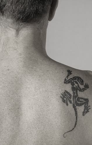 Tatuaje de un lagarto que parece trepar por la espalda de este hombre, un tatuaje muy común desde finales desde los noventa y que aunque no estuvo tan de moda como los tribales, si es cierto que fueron muchas personas las que se hicieron lagartos como tatuajes