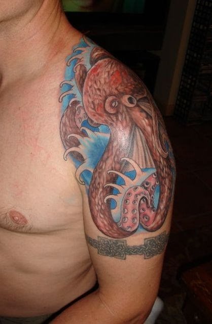 Tatuaje de un colorido pulpo sobre fondo marino conseguido con un oleaje blanco y turquesa muy bien trazado, al igual que el pulpo ha sido muy bien rellenado consiguiendo un buen resultado de un tatuaje marinero