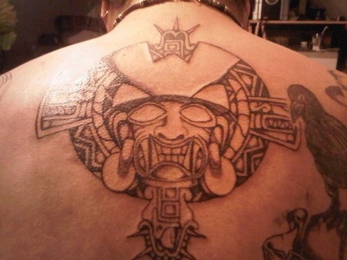 En el centro de la espalda, un dios azteca rodeador de otros tattoos como podemos ver en la imagen